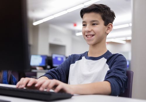 Smiling middle school student in computer lab