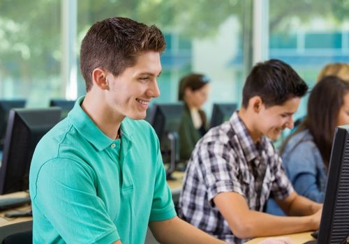 Teenagers during high school computer lab class