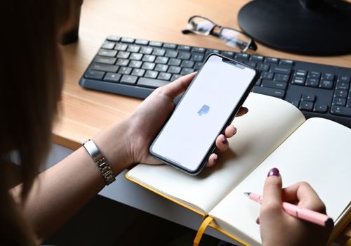 Woman Using A Mobile At Workstation