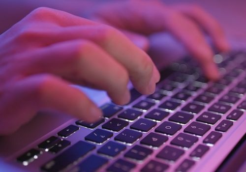 Hands Typing on Computer Keyboard