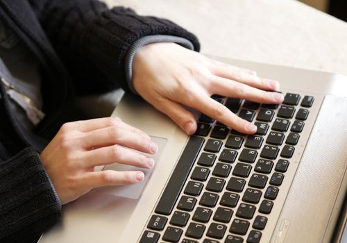 Person Working On Gray Laptop Keyboard