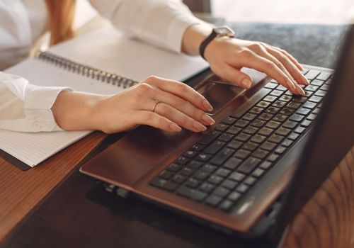 Office Secretary Working On Laptop