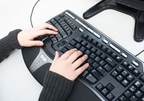Woman Working with Ergonomic Keyboard