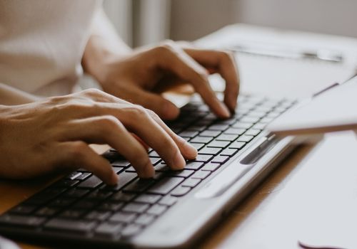 Male Hands Typing on a Wireless Computer Keyboard