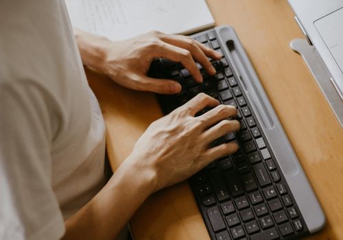 Man Typing on Wireless Computer Keyboard