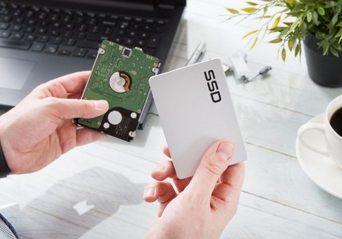 Man changes hard drive disk to a modern SSD