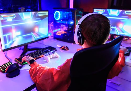 Young Man Playing a Game on Computer