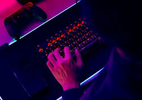A Gamer Using a Backlit Computer Keyboard