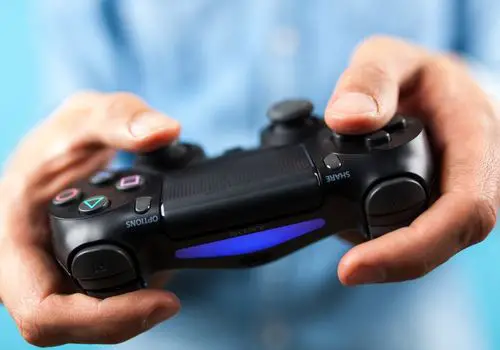 Man Holding a PS4 Controller