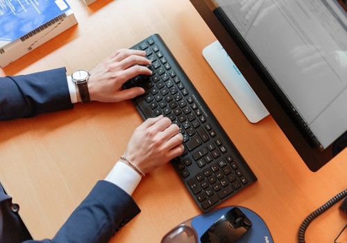 Person Typing on Computer Keyboard