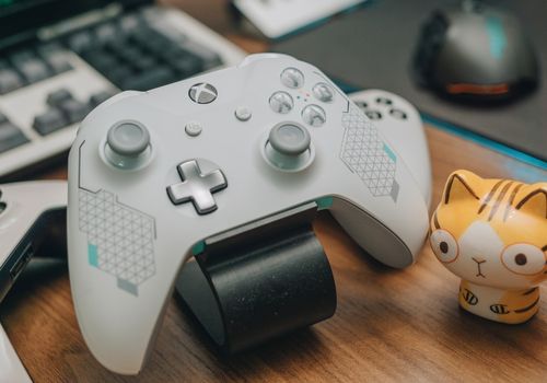 White Xbox Controller on Brown Wooden Surface