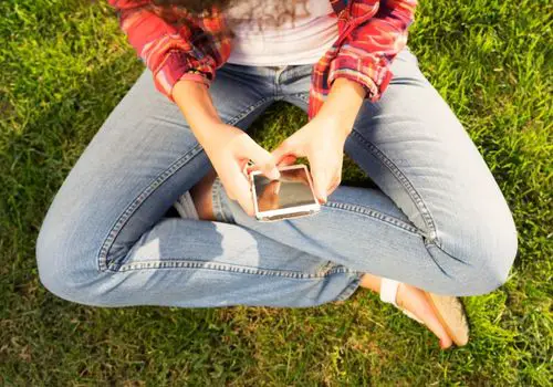 Young Woman Chatting with a Friend Using Mobile Phone