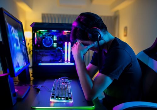 Frustrated Man in front of a Gaming PC