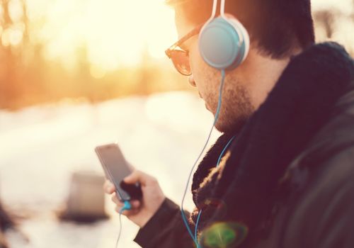 Man with Headphones Making a Phone Call