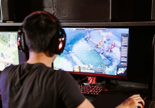 Man with Headphones Playing a Computer Game