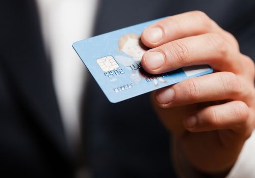 Person Holding a Debit Card