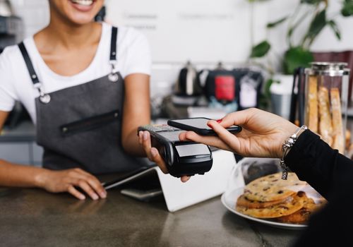 Person Paying the Cashier Using Smartphone