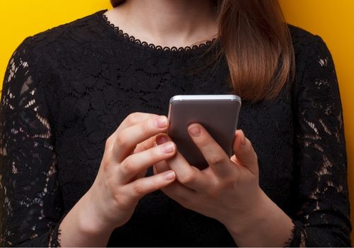 Female Hands Holding a Mobile Phone