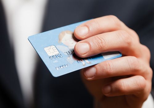 Man Holding a Debit Card