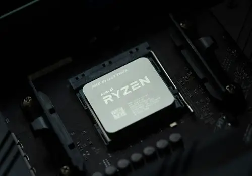 An AMD Ryzen is placed onto a black motherboard