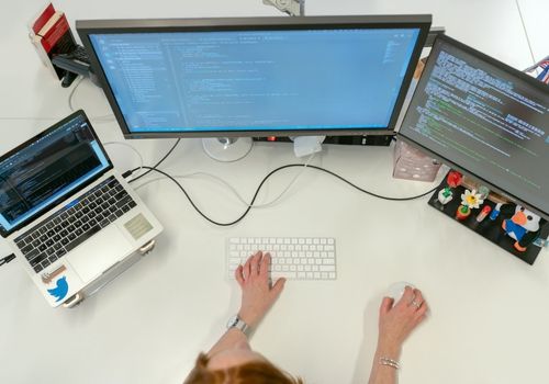 Female Software Engineer Coding on Computer