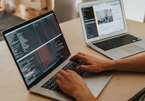 Person Coding on a MacBook Pro