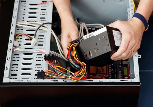 Person Fixing PC Power Supply