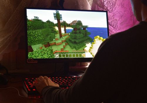 Person Playing Minecraft Game on PC