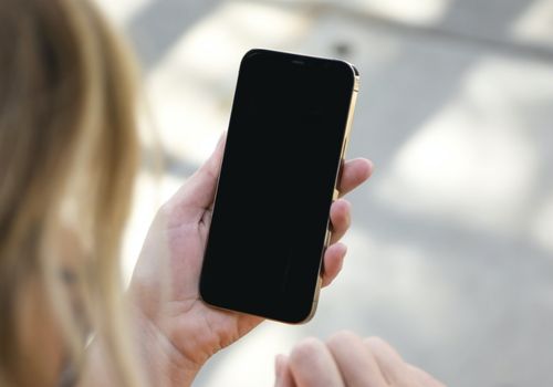 Woman Holding Black iPhone 5