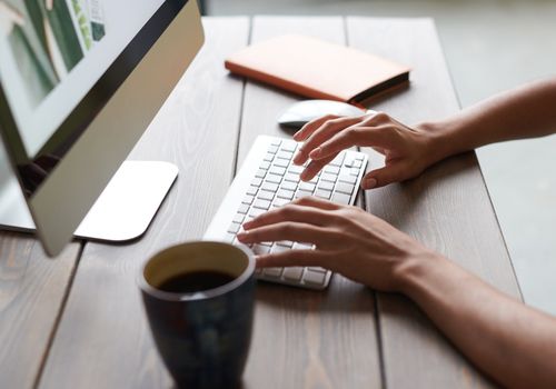 Woman Working on the Desktop Computer