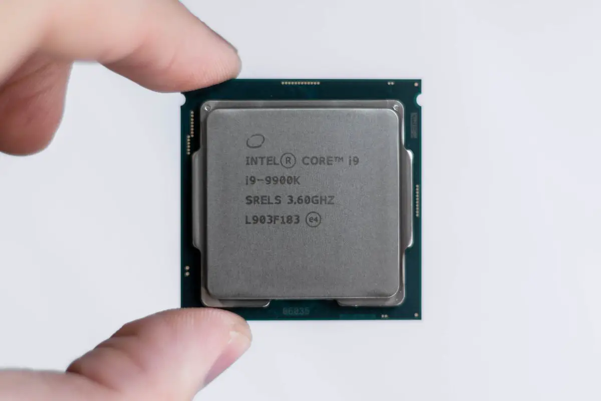 Hands Holding Intel Core i9 9900k Processor