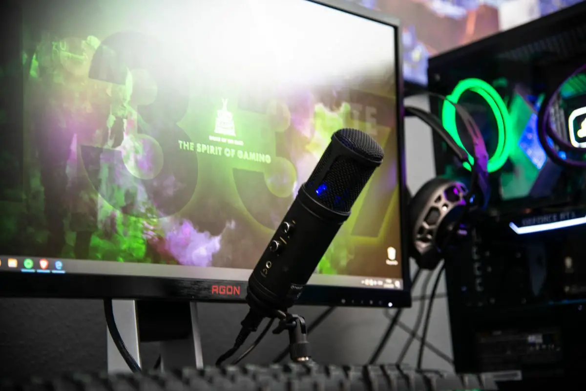 Black Microphone Beside Gaming Monitor