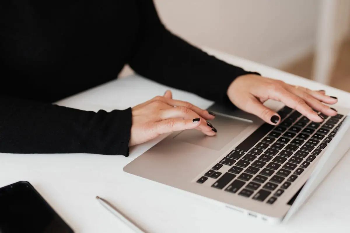 Black Nailed Woman Working on the Laptop