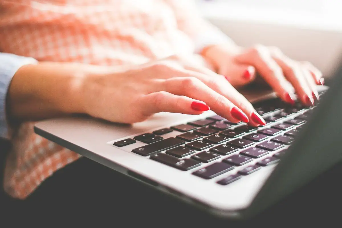 Female Hands Typing on the Laptop Keypads