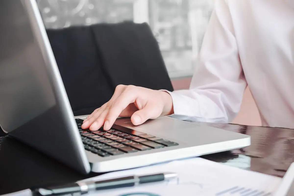 Person Wearing White Shirt Using a Laptop