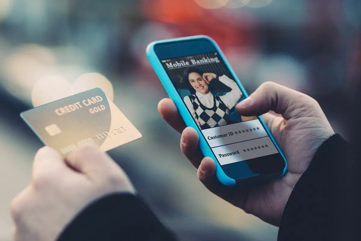 Man Holding Credit Card and Using Mobile Payment Technology