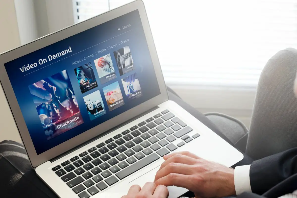 Man Using Laptop for Watching Movie on VOD Service