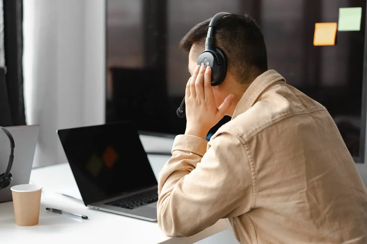 Man Wearing Headphones and Sitting Front of the Laptop
