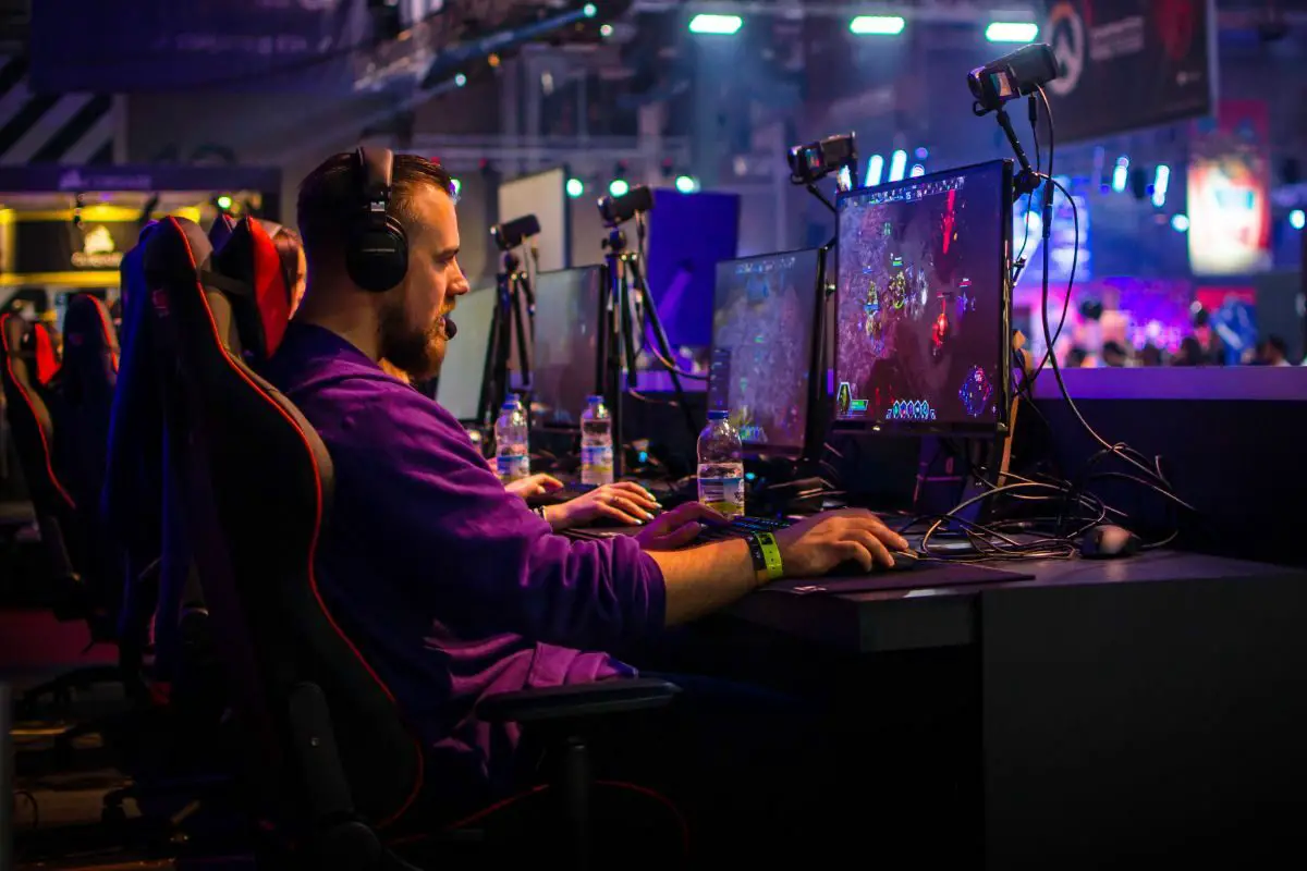 Man with Headphones Playing Online Game at PC Games Hub