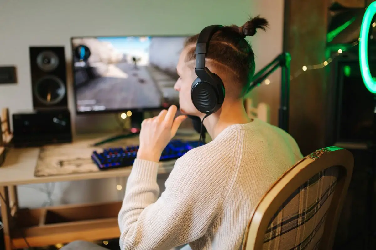 Man with Headphones Playing a Computer Game