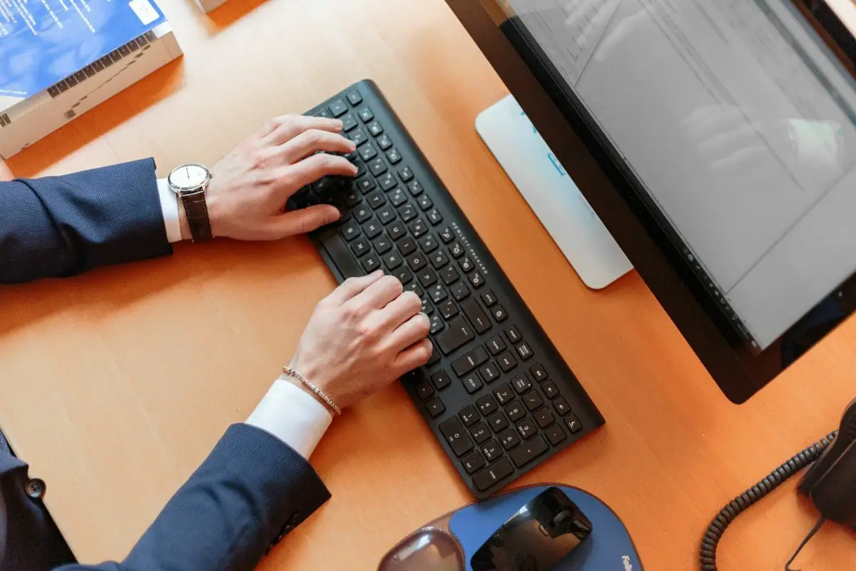 PC User Typing on the Black Keyboard