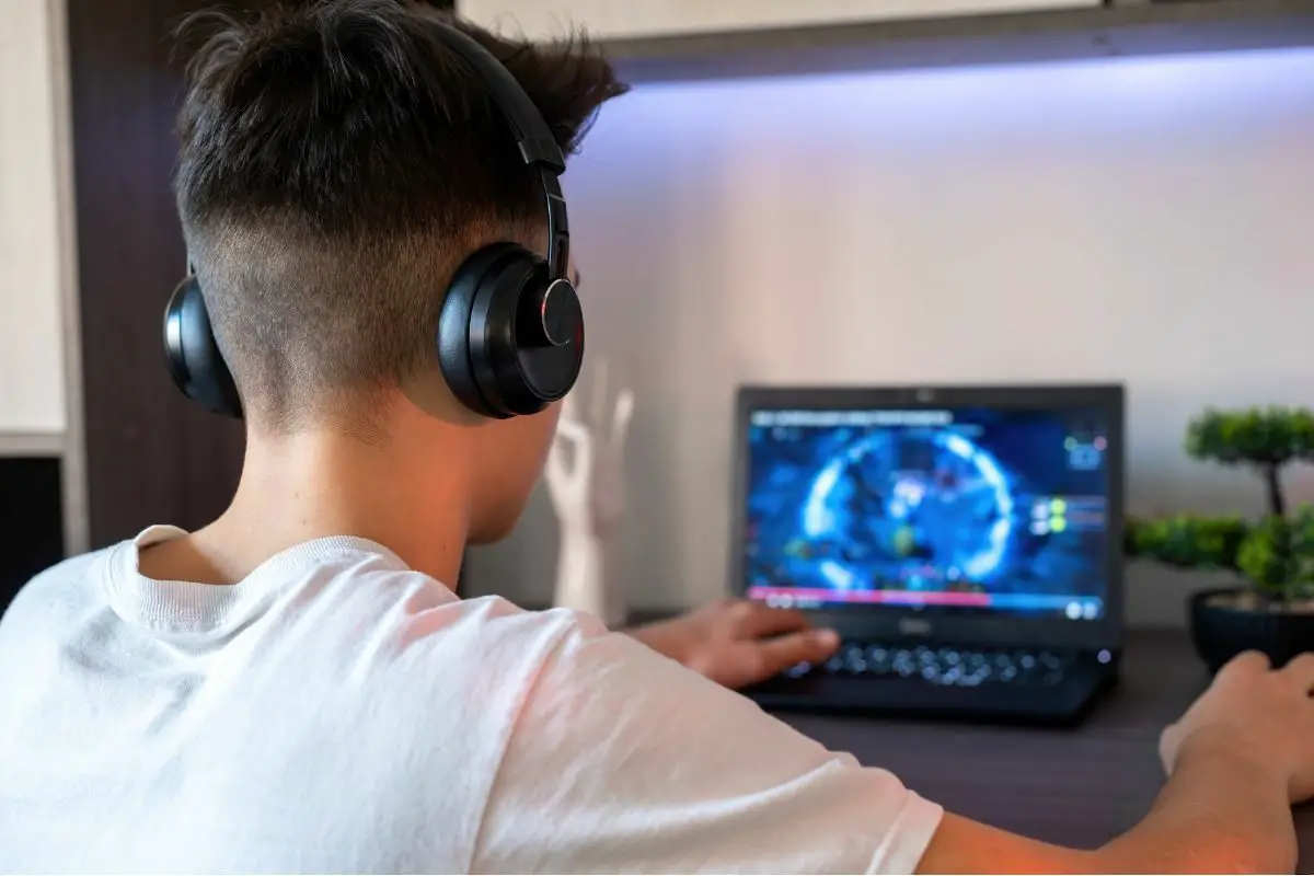 Teen with Headphones Playing Computer Games