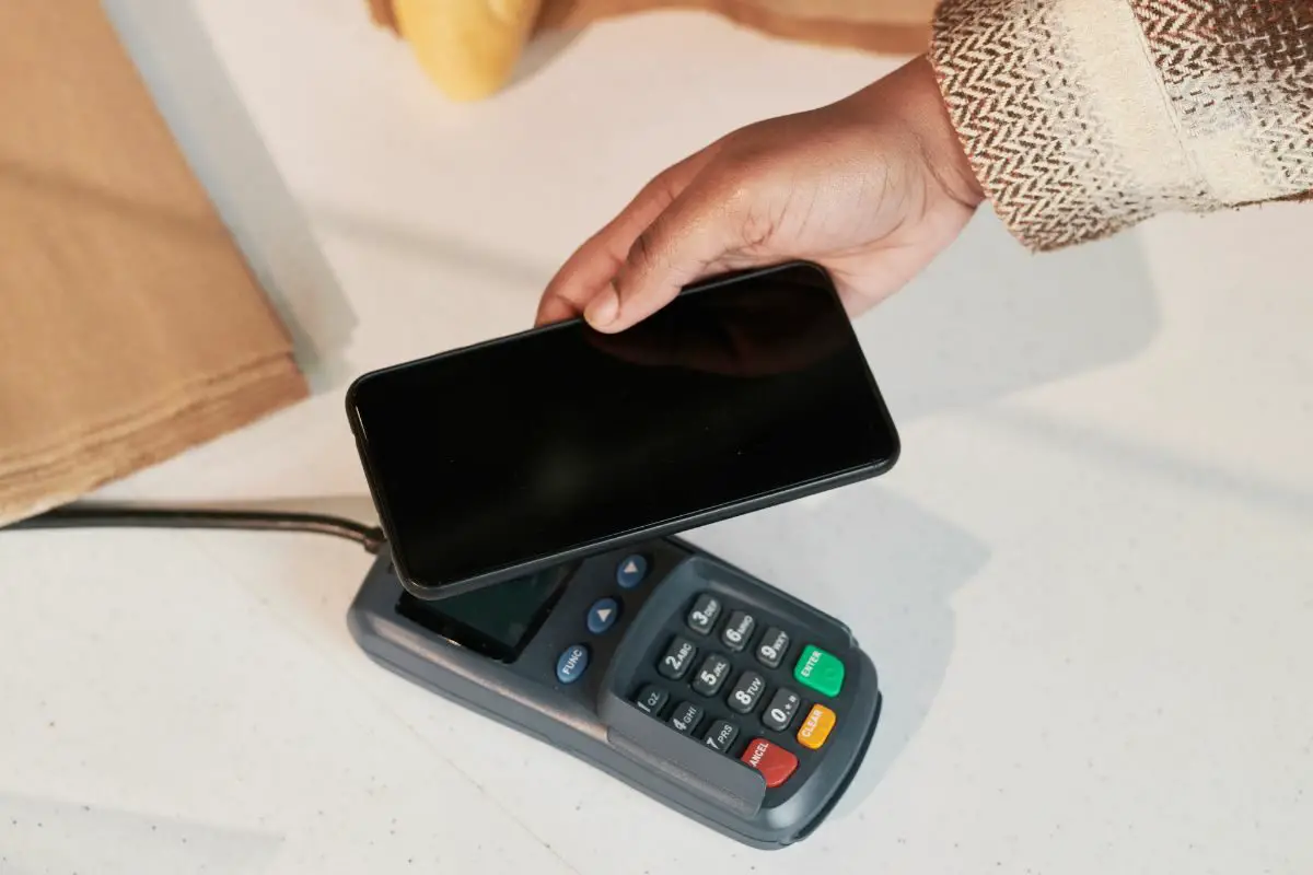 Woman Making Payments Using Smartphone