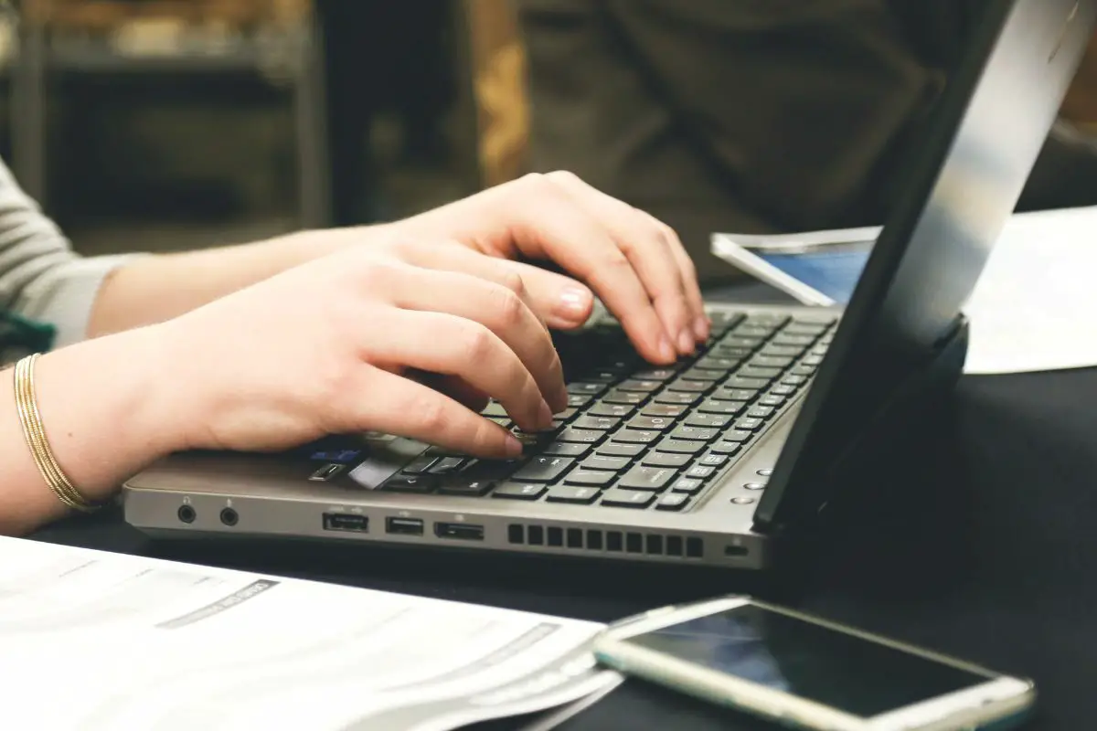 Woman Typing on Laptop