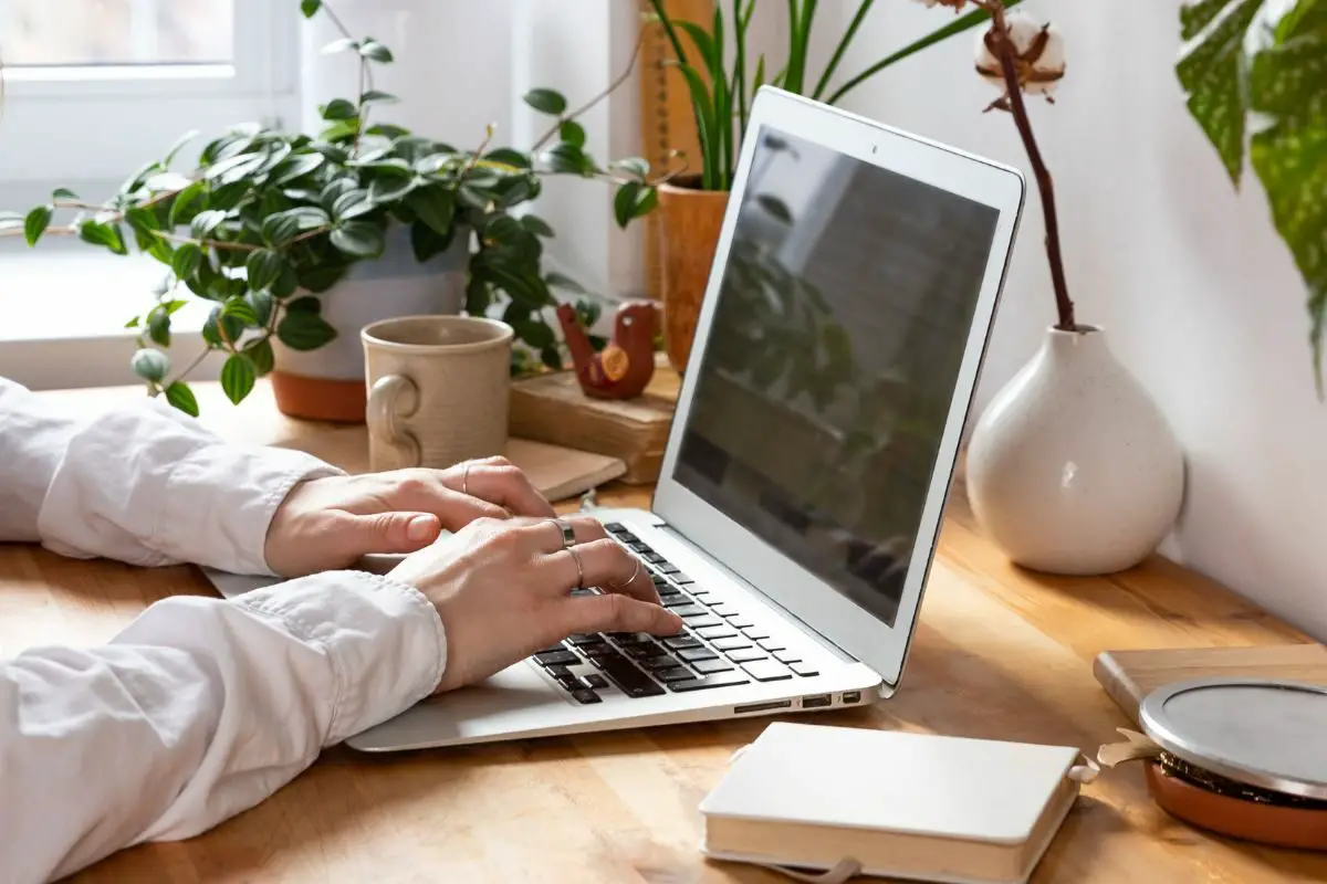 Woman Wearing Full Sleeve White Shirt Working on the Laptop