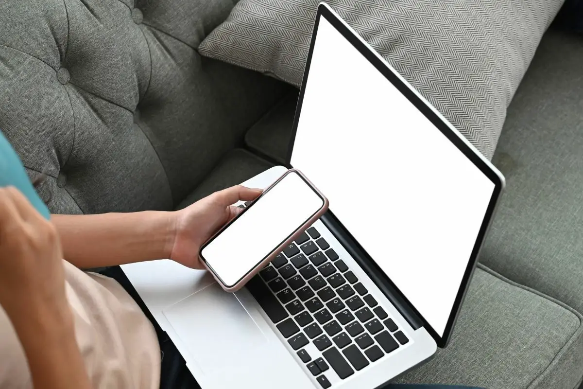 Young Female Tech Using a Mobile and Laptop