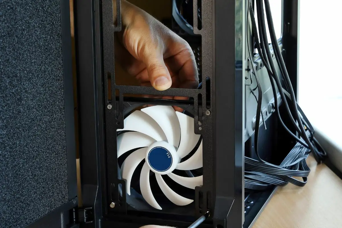 Hands Placing a Cooling Fan to a Computer Case