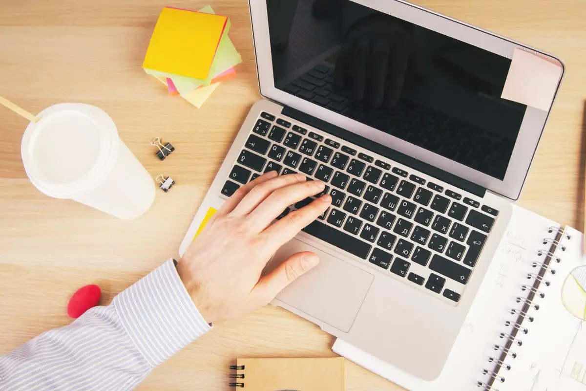 Male Using Laptop on the Desk with Office Accessories