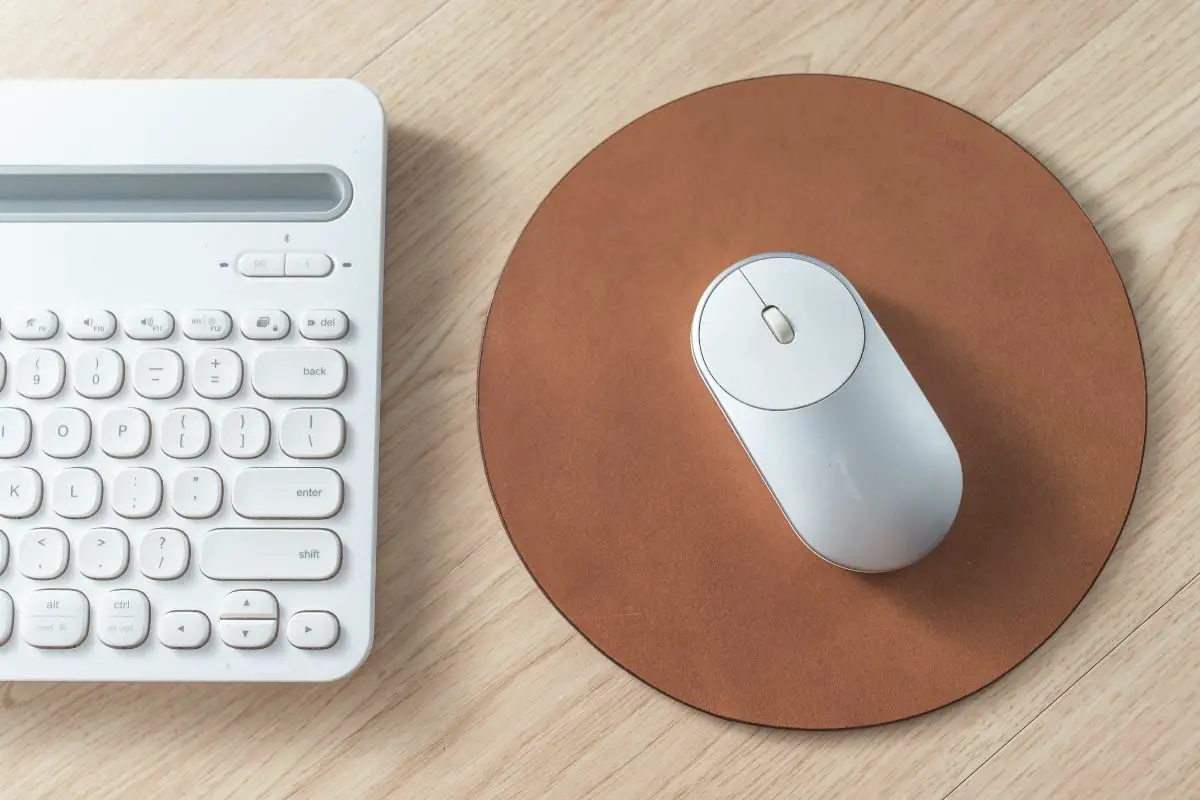 Wireless Mouse Placed on top of Leather Mouse Pad