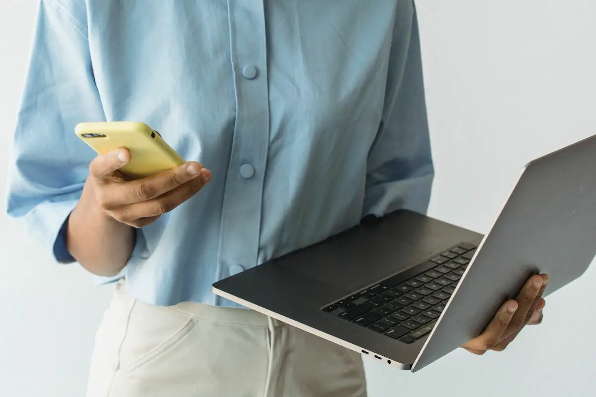 Woman Holding Laptop and Smart Phone